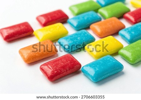 A close-up macro shot of colorful rectangular chewing candies isolated on a white background. Perfect for commercial packaging.
