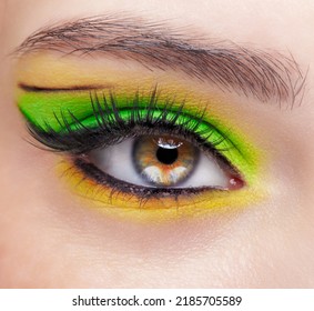 Closeup macro shot of human female eye. Woman with vogue face beauty makeup. Girl with green and yellow eyes shadows. - Shutterstock ID 2185705589