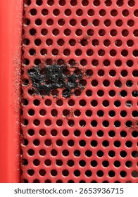 Close-up Macro Shot of Rusty Red Speaker Grill Texture