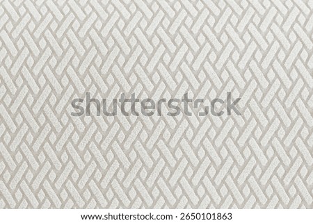 Close-up macro shots of textile patterns in soft beige tones. Various geometric woven and tufted textures are shown with shallow depth of field, highlighting the fabric’s tactile quality. Ideal for ba