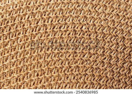 Close-up macro texture of a braided straw hat, abstract background