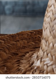 Close-up macro texture of a woven straw hat showing intricate traditional braiding details.