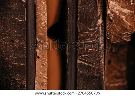 Close-up macro view of assorted chocolate bar edges with layered textures and rich tones, perfect for confectionery branding, dessert advertising, and premium food packaging