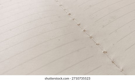 Close-up Macro View of Open Lined Journal Pages Showing Visible Spine Stitching and Hand-Crafted Bookbinding Detail