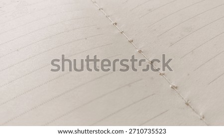 Close-up Macro View of Open Lined Journal Pages Showing Visible Spine Stitching and Hand-Crafted Bookbinding Detail