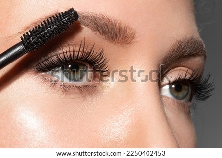Close-up of make-up blue eye with long lashes with black mascara