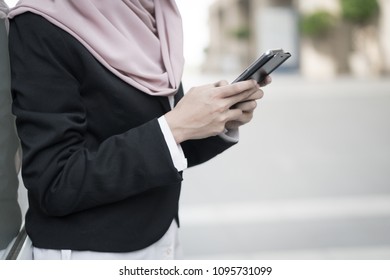 Close-up Of Malay Girl Holding Mobile Phone Outdoor