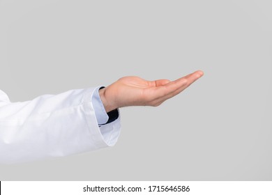 Closeup of male doctor's hand ponting or holding virtual object on open palm over white studio background - Powered by Shutterstock