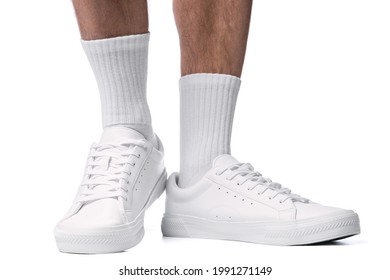 Closeup Of Male Feet And Shoes. Man Wearing White Trainers Isolated On White Background.