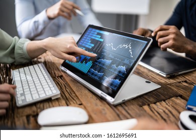 Close-up Of Male And Female Businesspeople In Meeting Discussing Graphs - Powered by Shutterstock