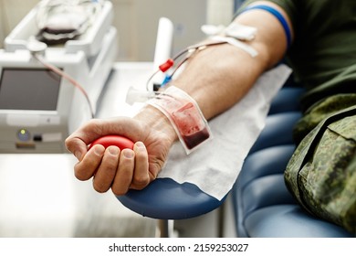 Closeup of male hand with blood bag at blood donation center, copy space