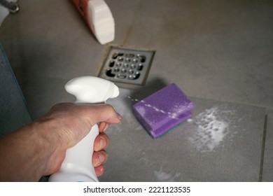 closeup of a male hand cleaning a bathroom floor with household ammonia  - Shutterstock ID 2221123535