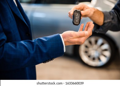 Closeup Of A Male Hand Giving Back His Clients Car Key Fob