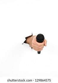 Close-up Of Male Hand Holding A Black Microphone Through A Torn White Paper, Isolated