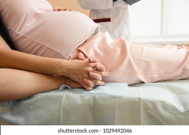 Close-up of male hand holding his pregnant wife hands - Powered by Shutterstock