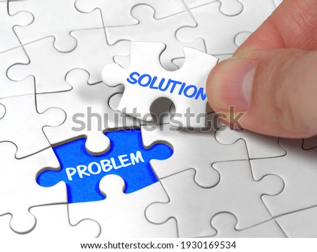 Closeup an male hand holding the jigsaw puzzle solution to the problem missing piece. Concept conceptual metaphor imagine.