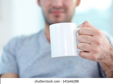 Close-up Of Male Hand Holding Mug