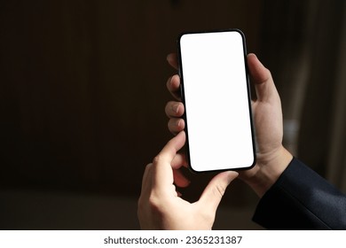 Close-up of male hand holding smartphone with white mockup on screen. - Powered by Shutterstock