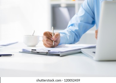 Close-up of male hand making notes in office - Powered by Shutterstock