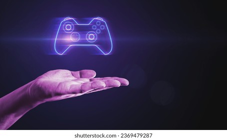 Closeup of male hand pointing at creative joystick or gamepad hologram on blurry purple bokeh background. Esport, gaming and fun concept - Powered by Shutterstock