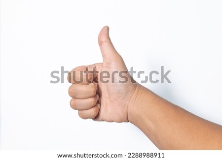 Close-up of male hand showing thumbs up sign on white background