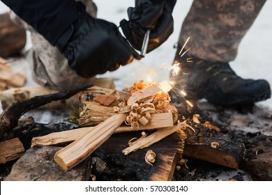 Closeup Of Male Hand Starts Fire With Magnesium Fire Steel, Fire Striker. Survival In Forest