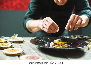 Close-up Of Male Hands Cooking Molecular Dish. Dark Background. Molecular Cuisine