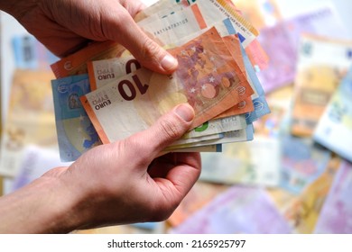 closeup male hands count paper euro banknotes of european union, paper bills on table, concept of cash, payments, savings, banking, save up for vacation, got low salary, social security, pay taxes