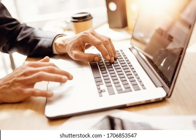 Closeup of male hands with laptop. Man working remotely at sunny studio. Freelancer at work - Shutterstock ID 1706853547