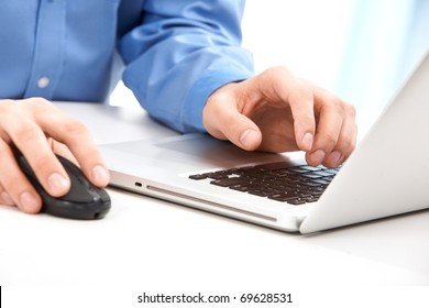 Close-up Of Male Hands On Mouse And Over Black Keyboard Of Laptop During Typing