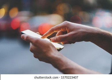 Close-up Of Male Hands Pointing Finger On Screen Smart Phone In City On The Background, Businessman Typing Messages On Her Cellphone In The City Center
