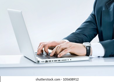 Close-up Of Male Hands Typing On Laptop Keyboard