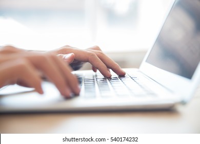 Close-up of male hands typing on laptop keyboard - Shutterstock ID 540174232