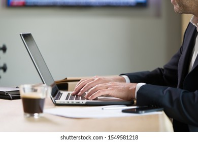 Close-up Of Male Hands Working On A Laptop In An Office Setting