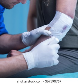 Close-up Of Male Paramedic Dressing Elbow Wound