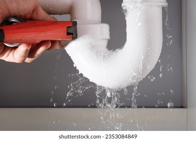 Close-up Of Male Plumber Fixing White Sink Pipe With Adjustable Wrench - Powered by Shutterstock