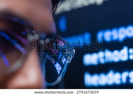 Close-up of Male Programmer with Coding Reflecting on Glasses. Asian Male Software Developer working on coding task looking at monitor analyzing and planning for software development task in office.