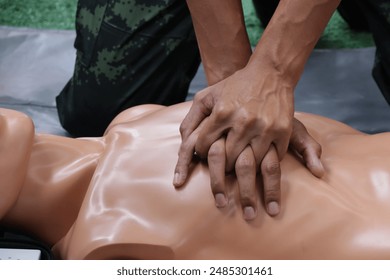 Close-up of a male soldier's hand A demonstration of defibrillation, lifesaving, at a human-shaped mannequin. - Powered by Shutterstock