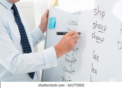 Close-up Of A Male Teacher Writing English Words On The Whiteboard