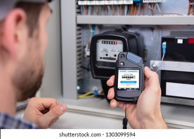 Close-up Of A Male Technician Doing Meter Reading - Shutterstock ID 1303099594