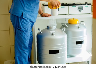 Closeup Of Male Technician Holding Rack In Nitrogen Tank. Cryo Sample Taken Out Of Liquid Nitrogen Cryo Storage In Laboratory.