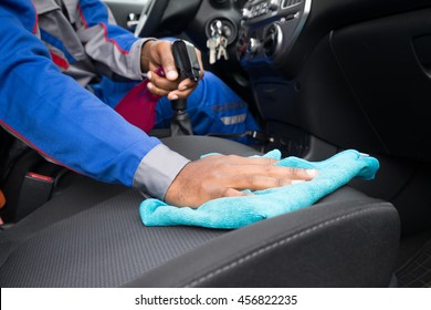 Close-up Of A Male Worker Cleaning Seat Inside The Car