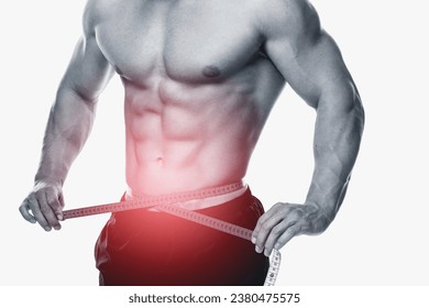 Close-up of a male's ripped torso and defined abs, intertwined with a measuring tape on white background - Powered by Shutterstock