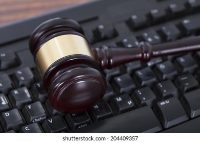 Closeup Of Mallet On Computer Keyboard In Courtroom