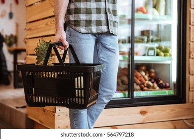 Closeup Of Man With Basket On Shopping At Grocery Shop