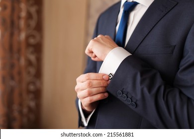 Closeup Of A Man In Black Suit Correcting A Sleeve.