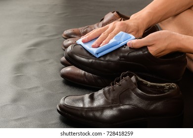 Closeup Of Man Cleaning His Leather Shoes.