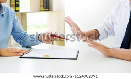 Closeup of a man do not want to Signing Contract or premarital agreement, filling petition form agreement of divorce in office at lawyer desk in court room  Conceptual of marriage.