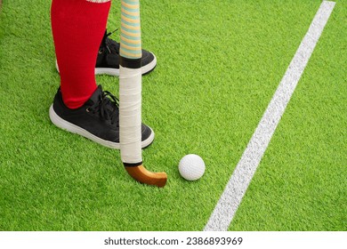 Closeup of a man field hockey player on the grass green background - Powered by Shutterstock