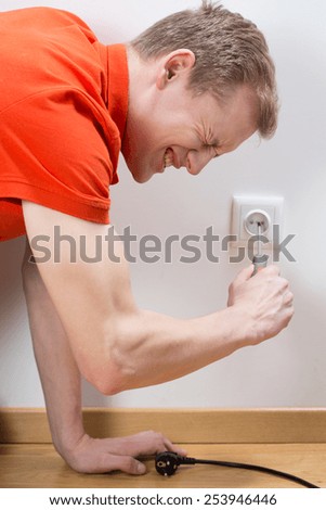 Close-up of man fixing socket being electrocuted